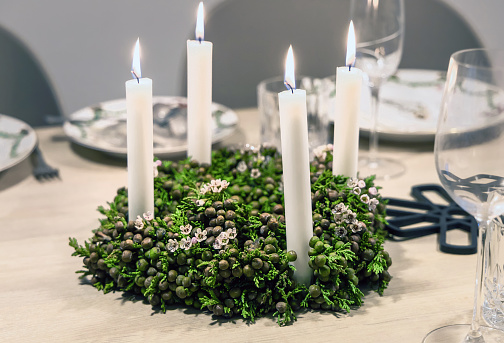 Decoration for the Christmas table. Wreath with candles.