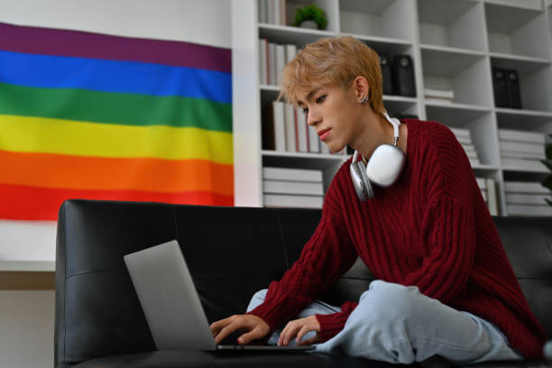 Portrait with Young Asian gay teenager learning online class with laptop, Take advantage of the free time concept by using technology. Portrait with Young Asian gay teenager learning online class with laptop, Take advantage of the free time concept by using technology. social awareness symbol audio stock pictures, royalty-free photos & images