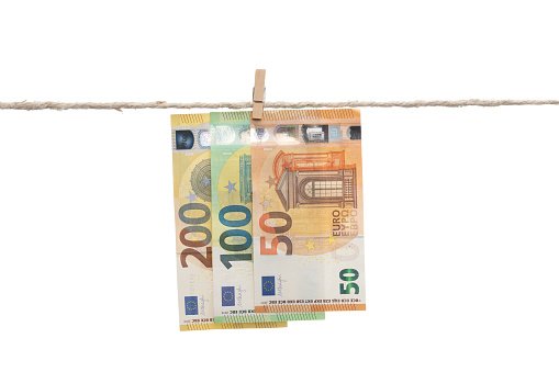 European Union currency hanging on frayed rope about to break isolated on white background