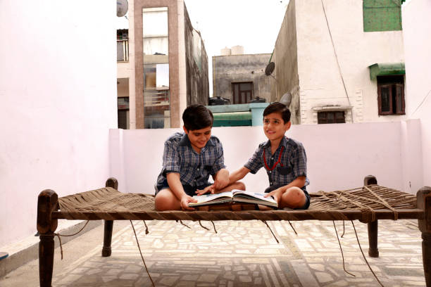 The brothers read together on two bunk beds in the nursery, the concept of kinship and childhood, a real interior, a dark style