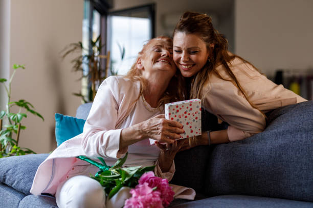 istock Woman opening a gift box her daughter surprised her with 1598817406
