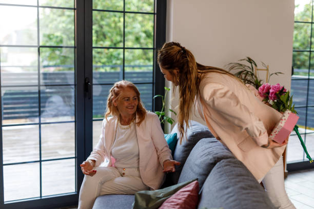 istock Woman surprising her loving mother with a gift 1598817410