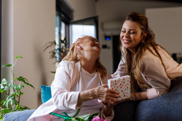 istock Woman opening a gift box her daughter surprised her with 1598817414