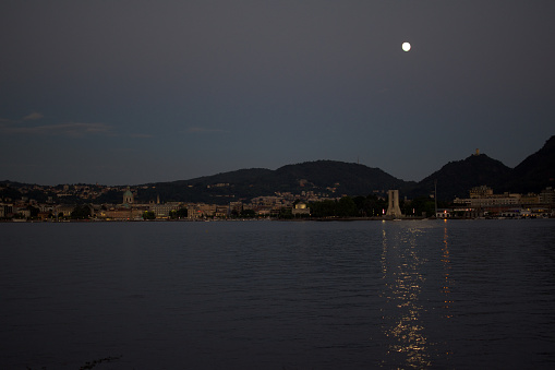 Romantic and charming lakeside of Como with historic buildings illuminated by the moon