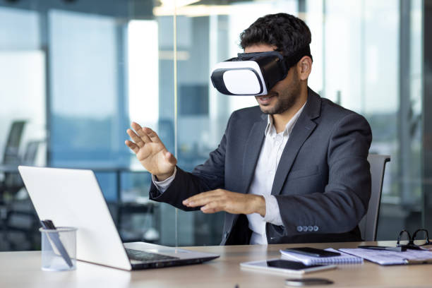 istock Businessman using vr glasses to view educational material and financial documents, graphs and tables online, financier inside office at workplace 1598828838