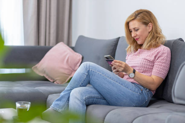 istock Woman using phone at home 1598849273