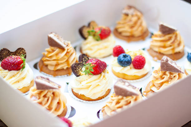 istock Assorted cupcakes in gift box with fresh strawberries, peanut butter, slated caramel, chocolate, raspberry, strawberry and blueberry 1598852059