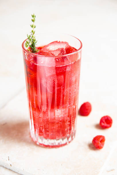 istock Red Raspberry Gin Cocktail Longdrink Lemonade Soda Drink with Berries and Thyme on bright kitchen counter 1598856933