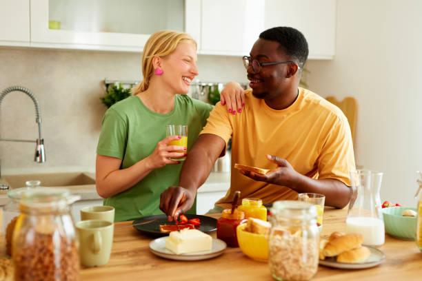 istock Multiracial couple enjoying breakfast together at home 1598858599