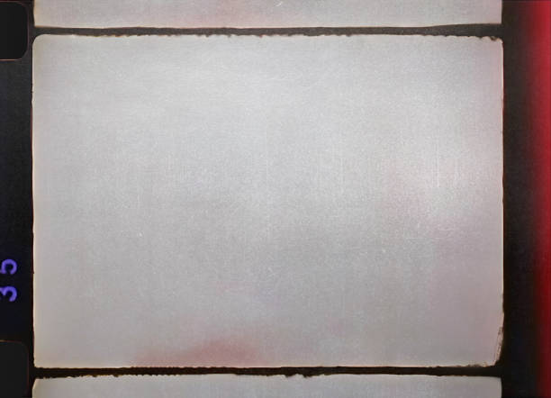 blank 16mm film frame with black border and scratches.