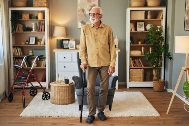Elderly man with walking cane at home