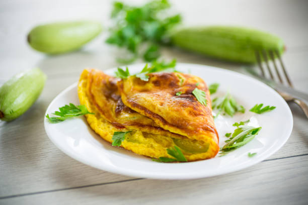 istock Fried omelet with zucchini, on a wooden table. 1598869242