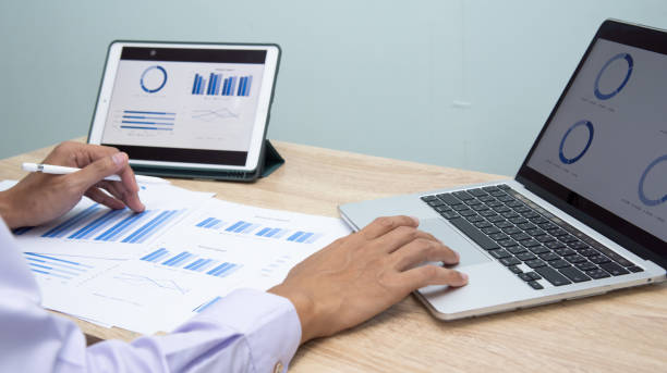 istock Businessman working at office with digital tablet, laptop computer, smart phone. Professional investor connection internet application online. Businessmen review annual company report. 1598874702