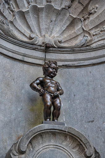 Brussels, Belgium - July 15, 2022: the famous Manneken Pis child peeing statue