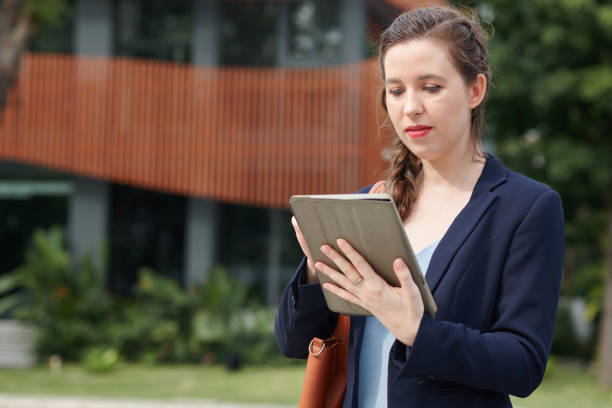 istock Businesswoman Reading Report on Tablet 1598916252
