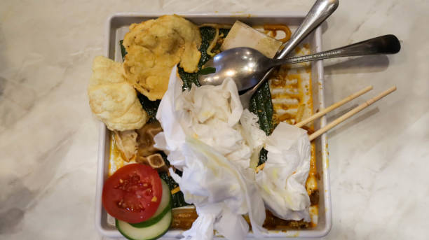 istock A plate fill with leftovers food, tissue, chopsticks, a fork and a spoon, happened after eating moment cleaning with tissue and put all the utensil in the bowl. 1598929842