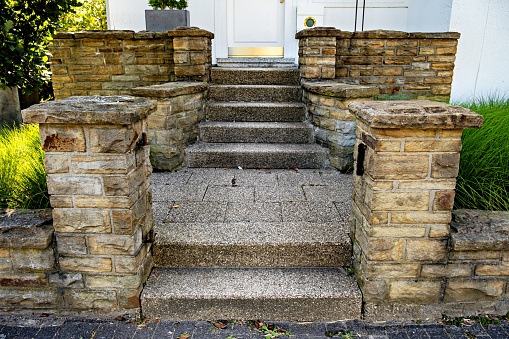 Set of stone steps leading up to front door of house in Germany.