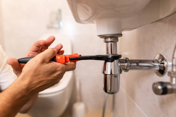 istock The plumber's hands using the wrench to fix the sink 1598934350
