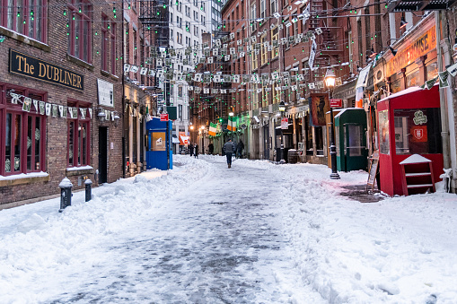 Lower Manhattan, New York City, New York, USA - March 14, 2017 - Snow on the cobblestone streets of Stone Street in lower manhattan's financial district