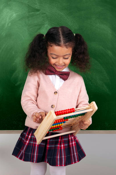 istock Little African-American Girl Dressed as Accountant using Abacus 1598946940