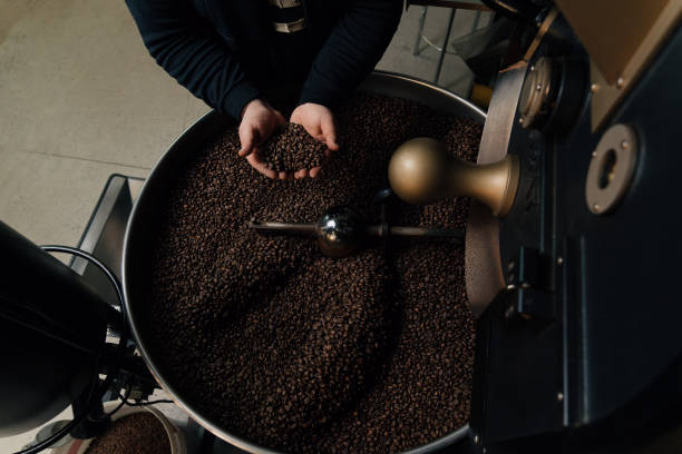 istock Crop man with handful of coffee beans 1598950147