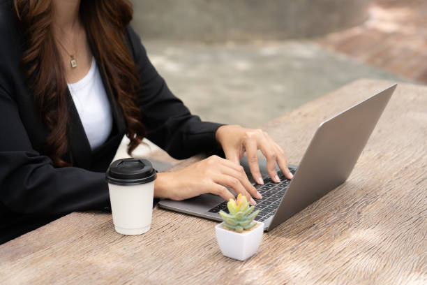istock busy businesswoman's skilled hand deftly juggled sleek tablet, a steaming cup coffee, and buzzing mobile phone, seamlessly multitasking to stay connected, informed, productive in her fast-paced world. 1598951850