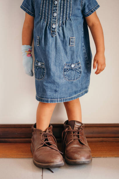 istock girl playing with daddy's shoes 1598954023