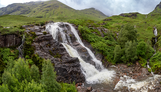 Glencoe waterfall at the Meeting of Three waters at the foot of Three Sisters mountains of Glen Coe Scottish Highlands Scotland