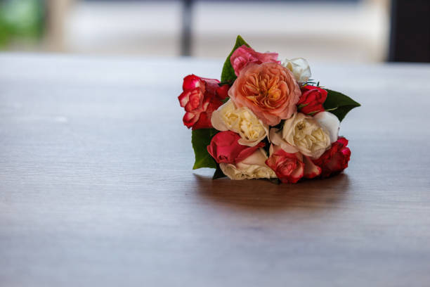 Close up shot of a beautiful bouquet of pink and white roses on a table with copy space.