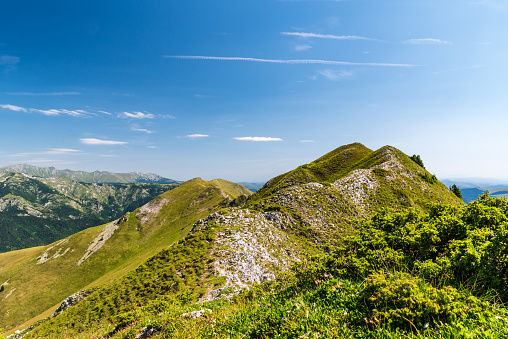 Narrow Oslea mountain ridge in Valcan mountains with Retezat mountains on the background in Romania