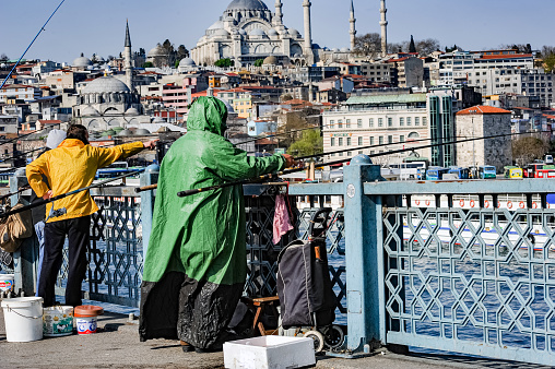 İstanbul, Turkey - April 16, 2011: People trying to fish with fishing rods in the Golden Horn