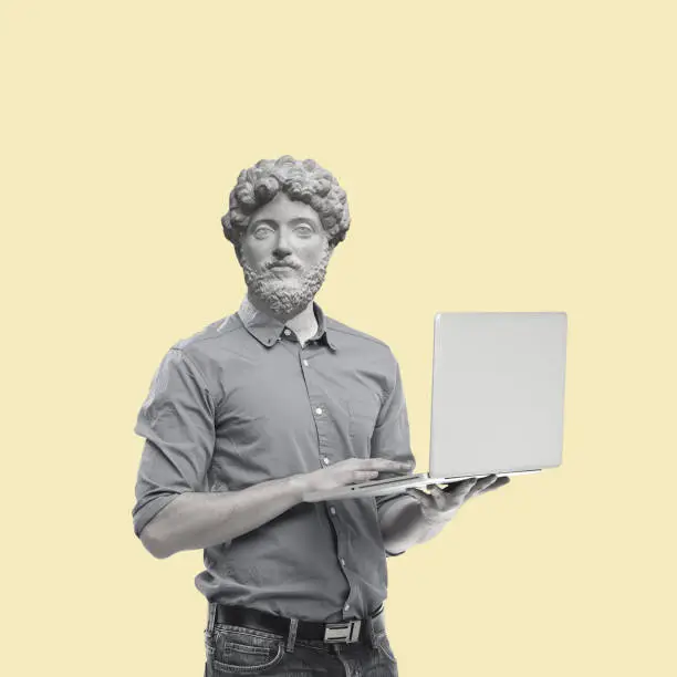 Photo of Contemporary art collage of a man headed by a statue head with a laptop.