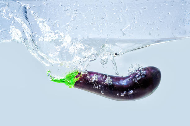 istock Eggplant dropped in water with splashes 1598997838