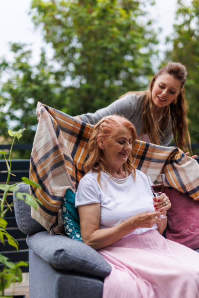 istock Caring woman making sure her mother is warm while enjoying a chilly evening on the balcony 1599000035