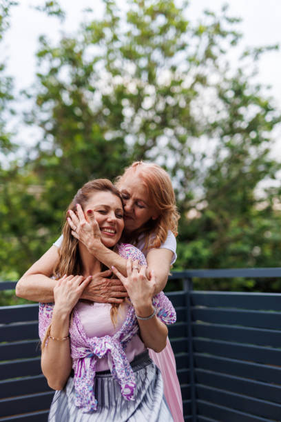 istock Caring mother embracing her daughter from behind, having bonding moments 1599003763