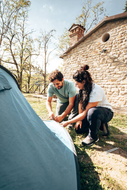 istock couple mounting the tent at the camping 1599004810