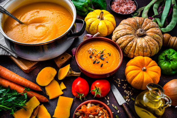 istock Pumpkin soup with ingredients on dark table 1599013456