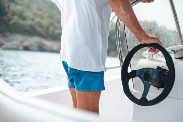 istock Man drives a motor boat in the sea. 1599037501