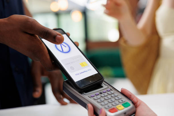 istock Man doing mobile nfc payment at hotel 1599039274