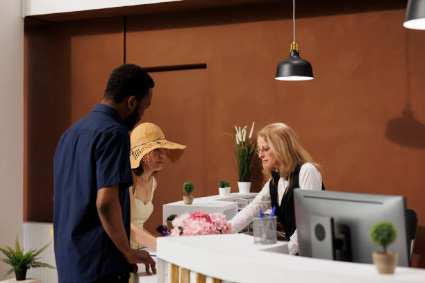 istock Receptionist helps guests with check-in 1599041460