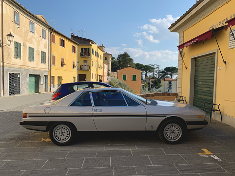 Lorenzana, Italy - March 20, 2023: a classic and undoubtedly elegant Lancia Gamma, dating several decades ago, is parked in the pictoresque small town of Lorenzana, in Tuscany. The car is a beautiful example of Italian design, with its sleek lines and curves