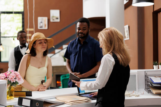 istock Receptionist looking at guests passports 1599072180