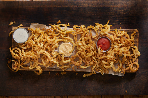 Crispy Buttermilk Onion Strings with Ketchup, Ranch and Burger Sauce Dipps