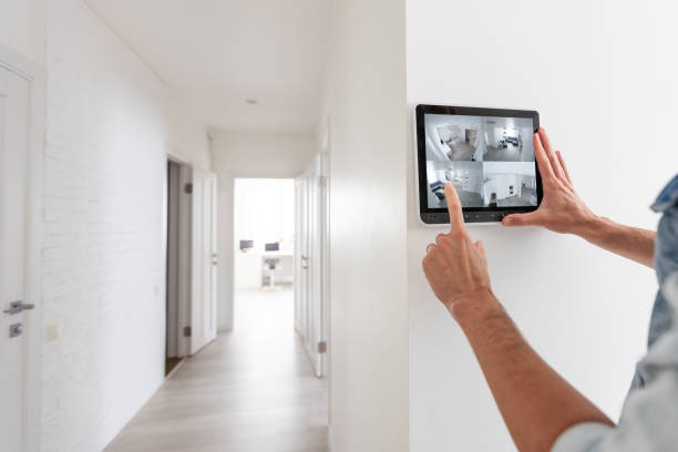 istock Augmented reality concept. Hand holding tablet with AR application used to simulate furniture and design products in an interior construction site, modern kitchen with Island, 3d illustration 1599111669