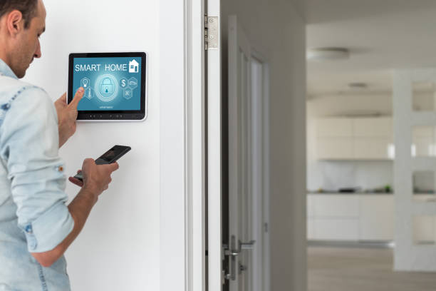 istock automation, internet of things and technology concept - man looking at tablet pc computer at smart home 1599115830