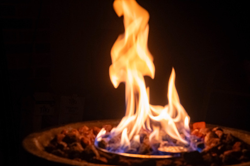 Gass fire place with stones and flames abstract background camping