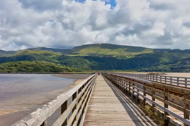 wooden bridge over the river with mountains landscape in Barmouth, UK