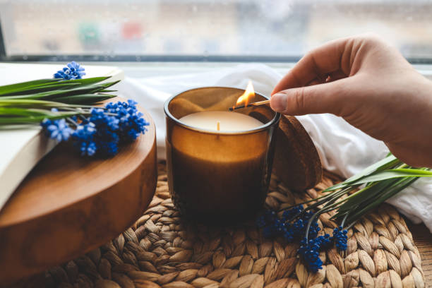istock Match in hand lights a candle, atmospheric photo 1599157726