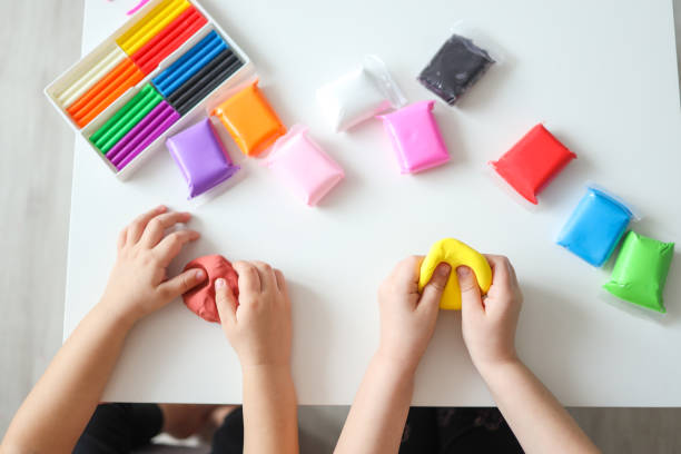 istock Children's hands modeling plasticine, top view, concept of creativity and education 1599171092
