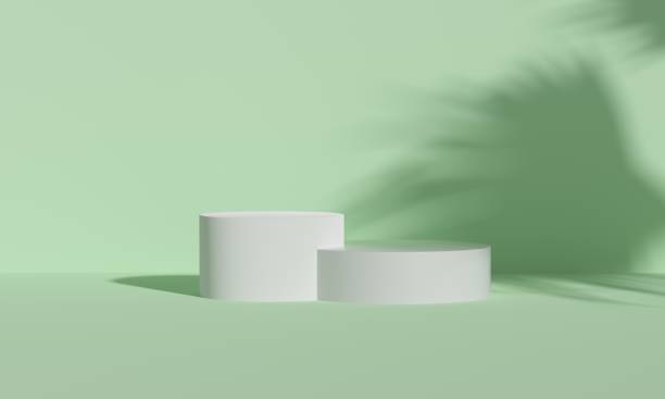 istock Podium platforms on green background with sunlight palm shade for product display. Empty podium platform. 3D Rendering. Natural products. 1599174340